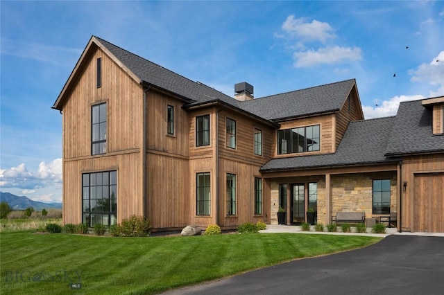 529 Clancy Way, Bozeman, MT 59718 - back of house featuring a shingled roof, a chimney, and a lawn