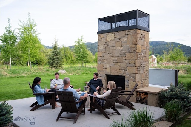 529 Clancy Way, Bozeman, MT 59718 - view of patio / terrace featuring an outdoor stone fireplace and a mountain view