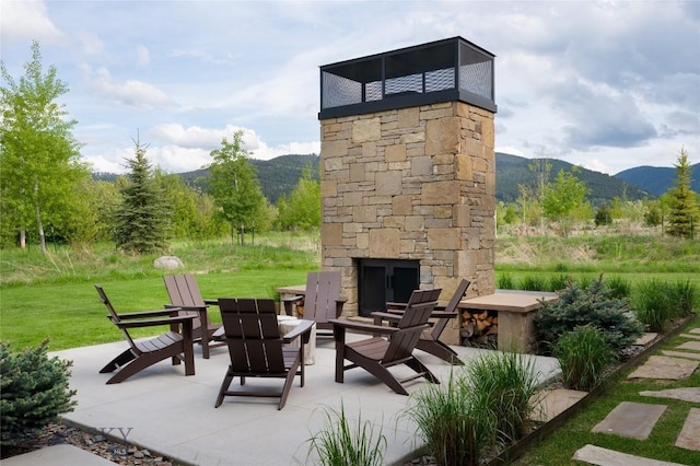 529 Clancy Way, Bozeman, MT 59718 - view of patio featuring an outdoor stone fireplace and a mountain view