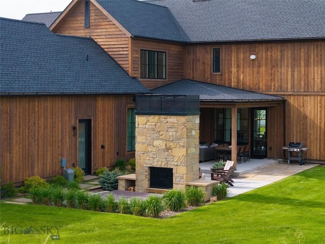 529 Clancy Way, Bozeman, MT 59718 - rear view of house featuring a stone fireplace, roof with shingles, a patio area, and a yard