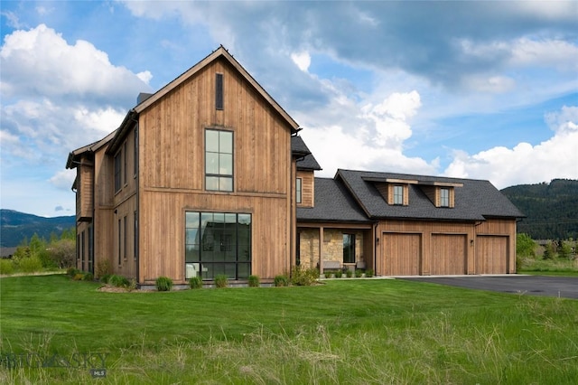 529 Clancy Way, Bozeman, MT 59718 - view of front facade featuring a front lawn, roof with shingles, driveway, and a mountain view