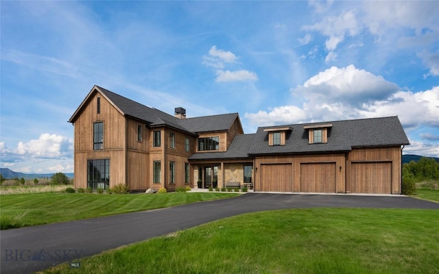 529 Clancy Way, Bozeman, MT 59718 - view of front facade with a front yard, driveway, and a chimney