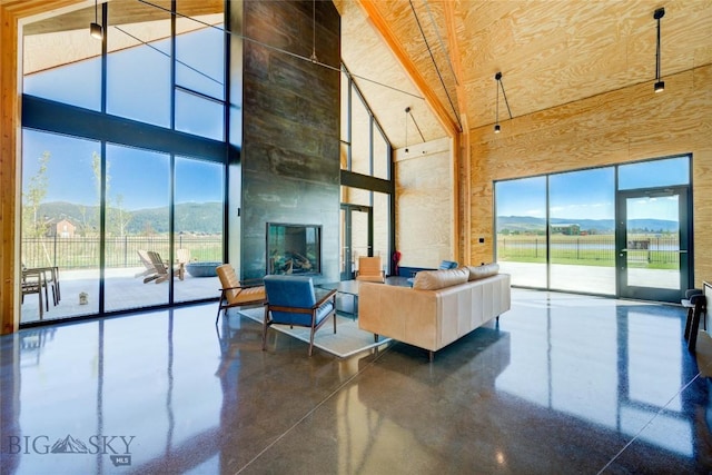 529 Clancy Way, Bozeman, MT 59718 - living room with a towering ceiling, a mountain view, finished concrete floors, and healthy amount of natural light