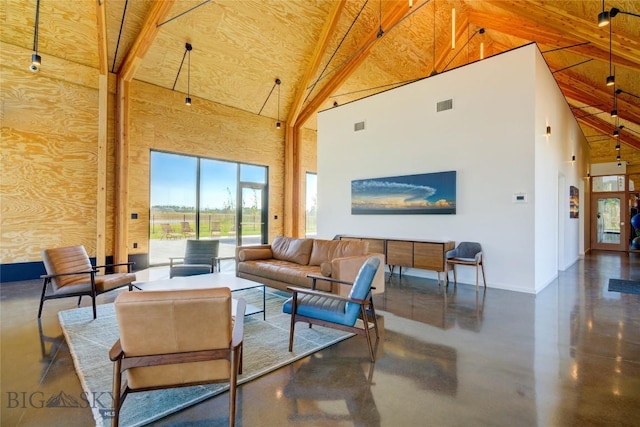 529 Clancy Way, Bozeman, MT 59718 - living area with high vaulted ceiling, finished concrete flooring, and beam ceiling