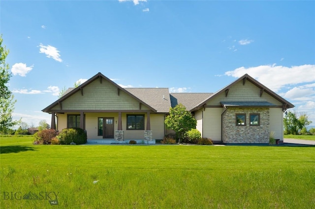 45 Spain Bridge Circle Dr, Belgrade, MT 59714 - craftsman-style house with stone siding, a front yard, and covered porch