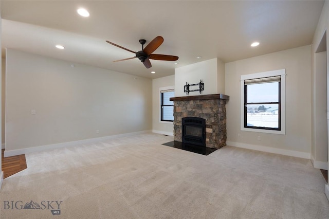 45 Spain Bridge Circle Dr, Belgrade, MT 59714 - unfurnished living room with light carpet, recessed lighting, ceiling fan, baseboards, and a stone fireplace