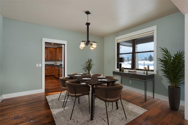 45 Spain Bridge Circle Dr, Belgrade, MT 59714 - dining area featuring baseboards, dark wood-style flooring, and a chandelier