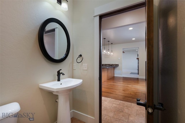 45 Spain Bridge Circle Dr, Belgrade, MT 59714 - half bathroom with baseboards, toilet, recessed lighting, and wood finished floors