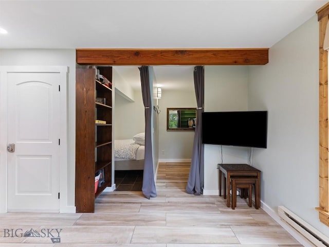 21 Sitting Bull Rd Unit 1190, Big Sky, MT 59716 - bedroom featuring a baseboard heating unit, a closet, wood tiled floors, baseboards, and recessed lighting