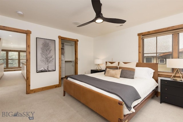 151B Pheasant Tail Unit B, Big Sky, MT 59716 - bedroom with light carpet, a ceiling fan, a walk in closet, and baseboards