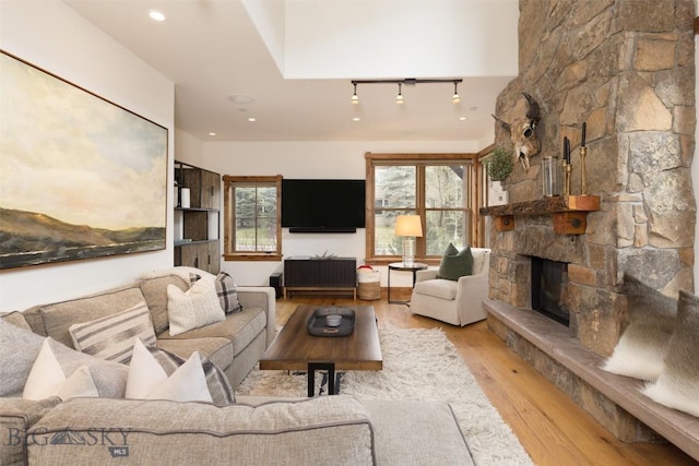 151B Pheasant Tail Unit B, Big Sky, MT 59716 - living room featuring wood finished floors and a stone fireplace