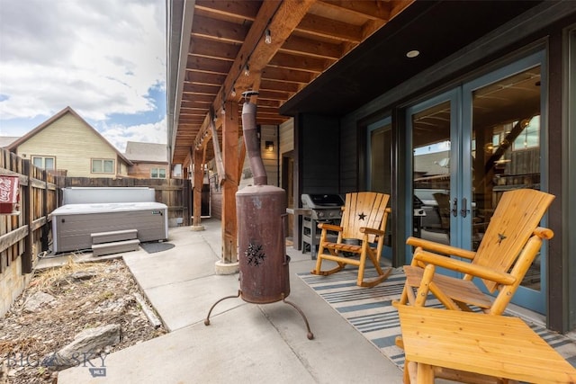 151B Pheasant Tail Unit B, Big Sky, MT 59716 - fenced backyard with a hot tub, a patio, french doors, and area for grilling