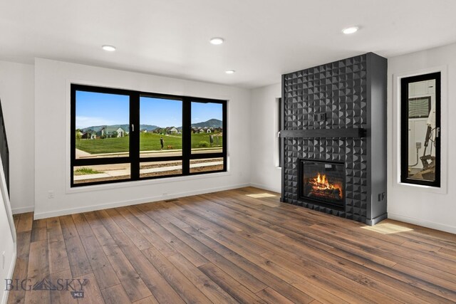 2939 S 30th Ave, Bozeman, MT 59718 - unfurnished living room with wood-type flooring, a fireplace, baseboards, and recessed lighting