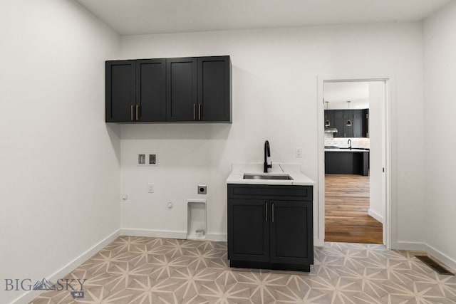 2939 S 30th Ave, Bozeman, MT 59718 - laundry area with gas dryer hookup, cabinet space, hookup for a washing machine, and baseboards