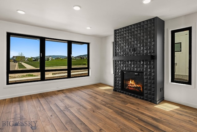 2939 S 30th Ave, Bozeman, MT 59718 - unfurnished living room with hardwood / wood-style flooring, a fireplace, baseboards, and recessed lighting