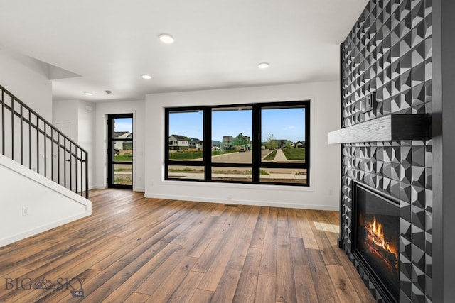 2939 S 30th Ave, Bozeman, MT 59718 - unfurnished living room featuring a fireplace, wood-type flooring, baseboards, recessed lighting, and stairway