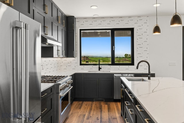 2939 S 30th Ave, Bozeman, MT 59718 - kitchen with appliances with stainless steel finishes, a sink, under cabinet range hood, tasteful backsplash, and recessed lighting