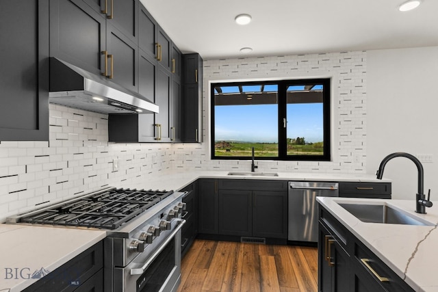 2939 S 30th Ave, Bozeman, MT 59718 - kitchen featuring appliances with stainless steel finishes, a sink, exhaust hood, wood finished floors, and recessed lighting