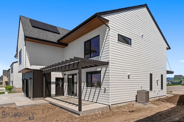 2939 S 30th Ave, Bozeman, MT 59718 - view of property exterior with solar panels, a pergola, central AC unit, a patio area, and roof with shingles