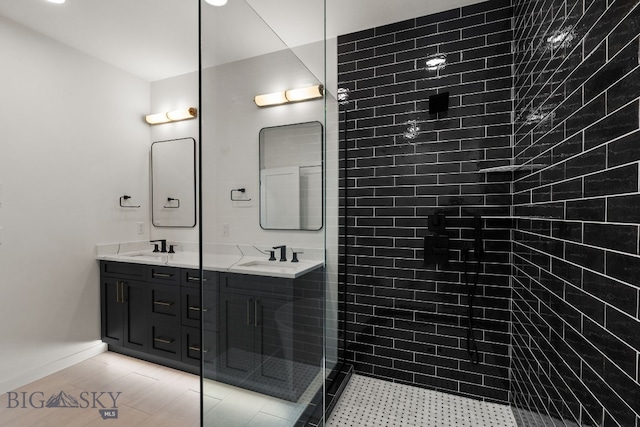 2939 S 30th Ave, Bozeman, MT 59718 - bathroom featuring double vanity, tiled shower, and baseboards
