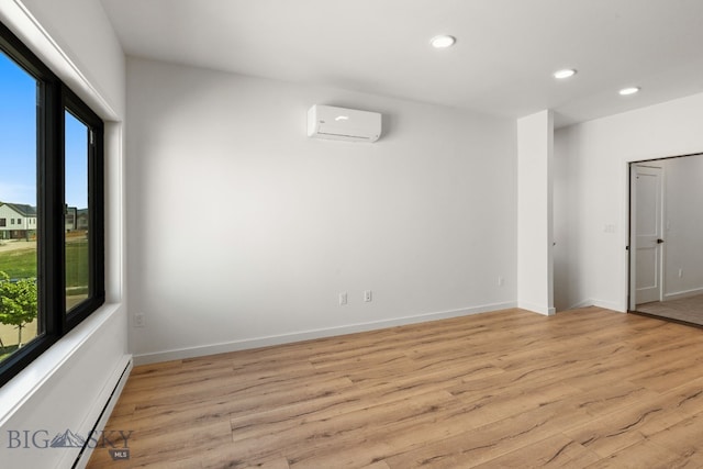 2939 S 30th Ave, Bozeman, MT 59718 - unfurnished room featuring healthy amount of natural light, a wall mounted air conditioner, recessed lighting, light wood-type flooring, and a baseboard radiator
