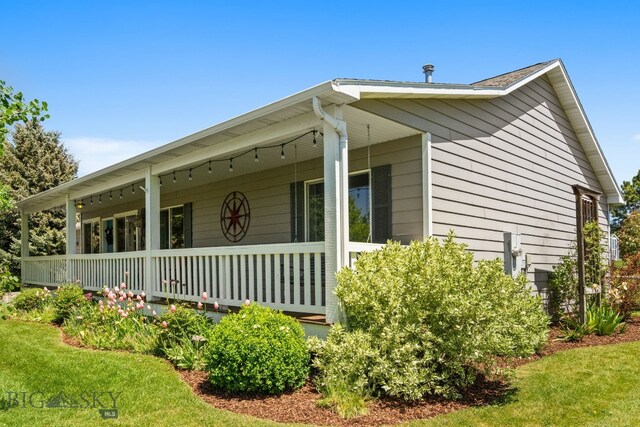 370 Prospector, Bozeman, MT 59718 - view of property exterior featuring covered porch and a lawn