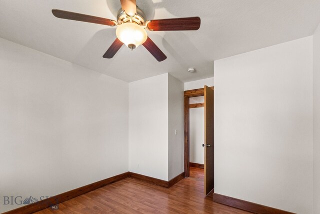 370 Prospector, Bozeman, MT 59718 - unfurnished room featuring wood finished floors, ceiling fan, baseboards, and a smoke detector