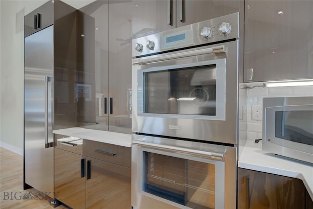 113 Nash Creek Ln, Bozeman, MT 59715 - kitchen featuring modern cabinets, stainless steel appliances, light countertops, and light wood finished floors