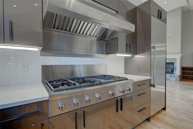 113 Nash Creek Ln, Bozeman, MT 59715 - kitchen with ventilation hood, modern cabinets, light countertops, and stainless steel gas cooktop