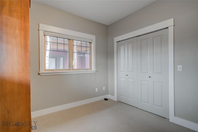 113 Nash Creek Ln, Bozeman, MT 59715 - unfurnished bedroom featuring carpet, a closet, and baseboards