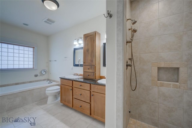 113 Nash Creek Ln, Bozeman, MT 59715 - bathroom featuring double vanity, a garden tub, a tile shower, tile patterned floors, and toilet