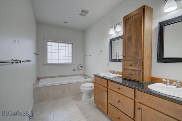 113 Nash Creek Ln, Bozeman, MT 59715 - full bathroom with double vanity, a bath, tile patterned flooring, and toilet