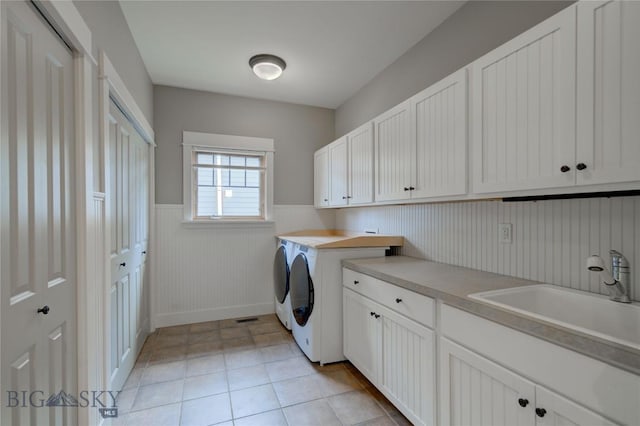 113 Nash Creek Ln, Bozeman, MT 59715 - laundry area featuring cabinet space, washer and clothes dryer, and wainscoting