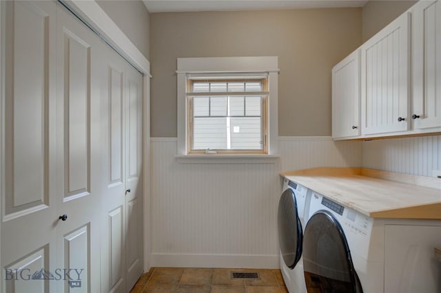 113 Nash Creek Ln, Bozeman, MT 59715 - washroom with cabinet space, washing machine and clothes dryer, and a wainscoted wall