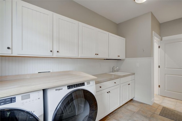 113 Nash Creek Ln, Bozeman, MT 59715 - laundry area featuring washer and clothes dryer, cabinet space, and wainscoting