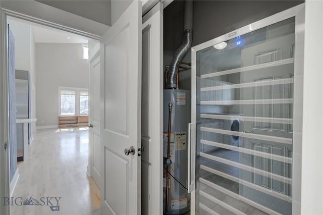 113 Nash Creek Ln, Bozeman, MT 59715 - hallway with gas water heater, light wood-type flooring, baseboards, and wine cooler