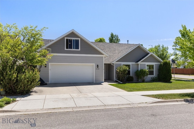 3194 Oliver St, Bozeman, MT 59718 - view of front facade featuring concrete driveway, a front yard, and an attached garage
