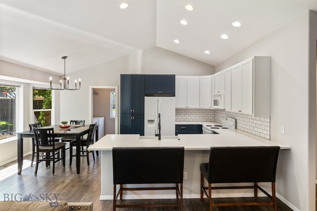 3194 Oliver St, Bozeman, MT 59718 - kitchen featuring white appliances, a sink, lofted ceiling, a peninsula, and light countertops