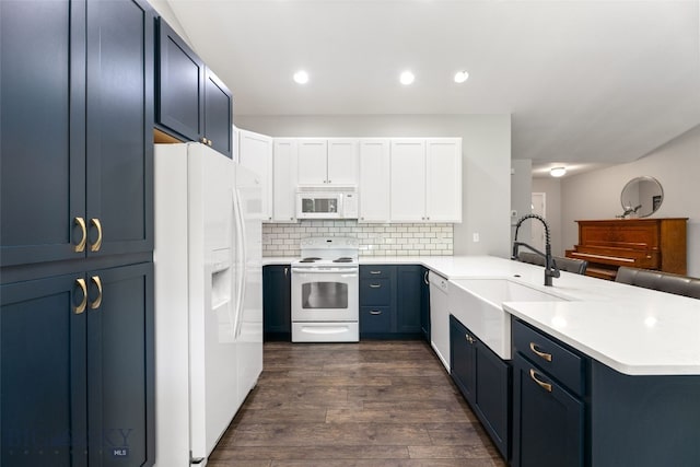 3194 Oliver St, Bozeman, MT 59718 - kitchen featuring white appliances, a sink, a peninsula, light countertops, and blue cabinets