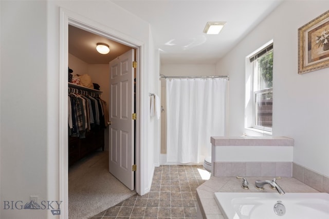 3194 Oliver St, Bozeman, MT 59718 - bathroom with a garden tub, a shower with shower curtain, a spacious closet, and toilet