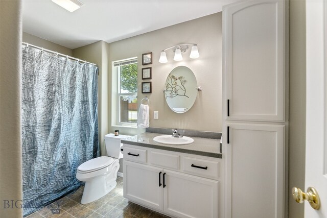 3194 Oliver St, Bozeman, MT 59718 - bathroom featuring toilet, vanity, and a shower with curtain
