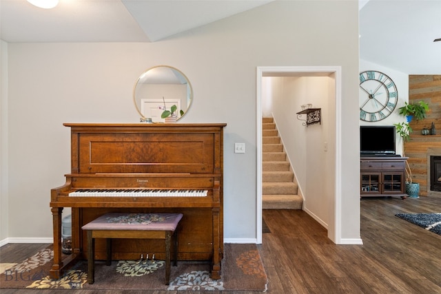 3194 Oliver St, Bozeman, MT 59718 - living area with stairs, dark wood-style floors, baseboards, vaulted ceiling, and a glass covered fireplace