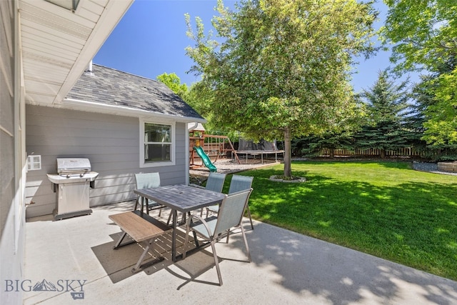 3194 Oliver St, Bozeman, MT 59718 - view of patio / terrace featuring a trampoline, area for grilling, outdoor dining area, and a playground