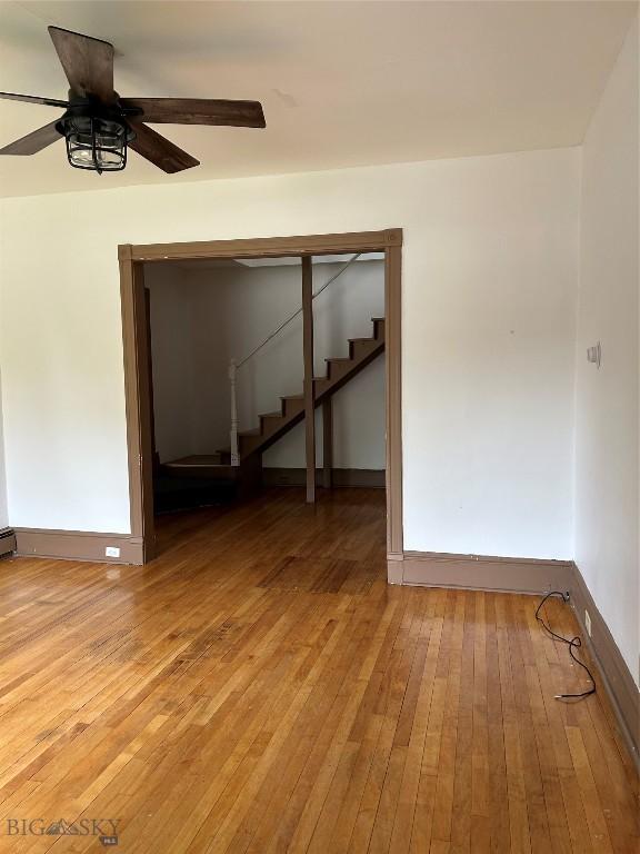 1106 Caledonia St, Butte, MT 59701 - unfurnished room featuring light wood finished floors, ceiling fan, stairs, and baseboards