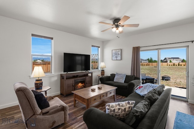 1165 Stewart Loop, Bozeman, MT 59718 - living area featuring a ceiling fan, a lit fireplace, wood finished floors, and baseboards