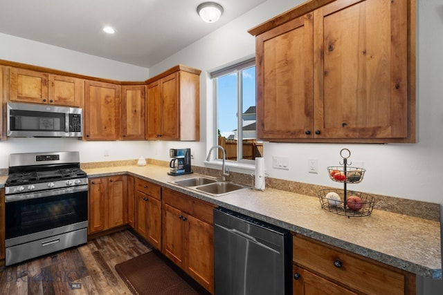 1165 Stewart Loop, Bozeman, MT 59718 - kitchen with stainless steel appliances, a sink, dark wood-type flooring, brown cabinetry, and recessed lighting