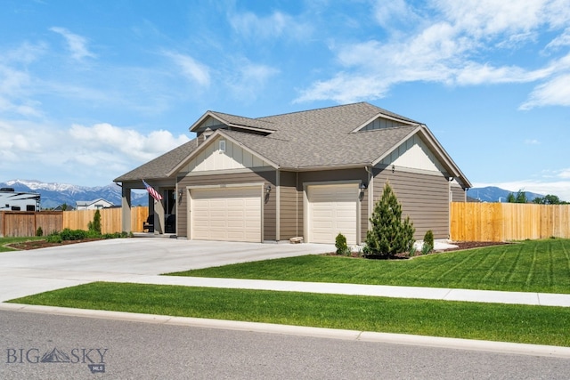 1165 Stewart Loop, Bozeman, MT 59718 - view of front of property with a mountain view, a garage, concrete driveway, and board and batten siding