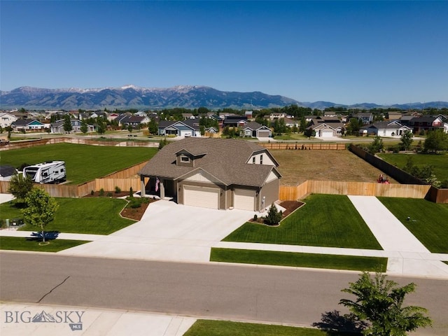 1165 Stewart Loop, Bozeman, MT 59718 - view of front facade featuring a garage, a residential view, a mountain view, and driveway