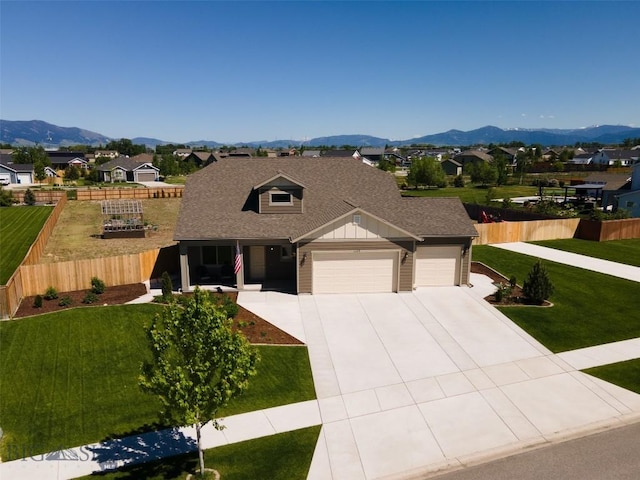 1165 Stewart Loop, Bozeman, MT 59718 - view of front of house with a garage, concrete driveway, a mountain view, and roof with shingles