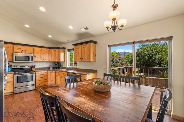 205 Water St, Sheridan, MT 59749 - kitchen with appliances with stainless steel finishes, vaulted ceiling, dark wood finished floors, recessed lighting, and dark countertops